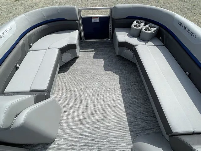 Slide: The Image of 2023 Bennington 20 SXL pontoon boat interior with gray seating and cup holders. - 6