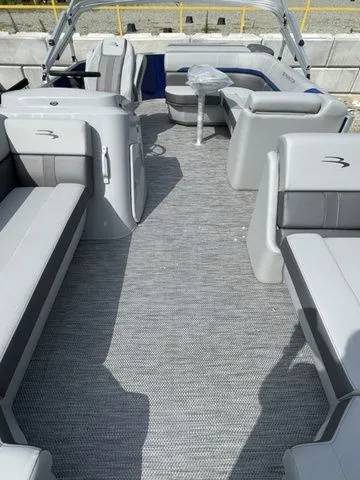 Slide: The Image of 2023 Bennington 20 SXL pontoon boat interior with gray seating and carpet. - 7