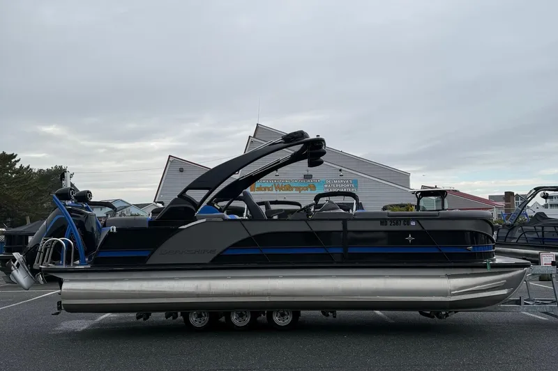 The Image of 2024 Berkshire 25RFX STS pontoon boat displayed outdoors on a cloudy day. - 0