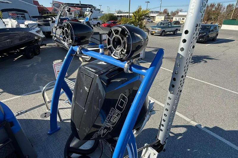 Slide: The Image of 2024 Berkshire 25RFX STS boat with powerful engine and sleek design in a parking lot. - 18