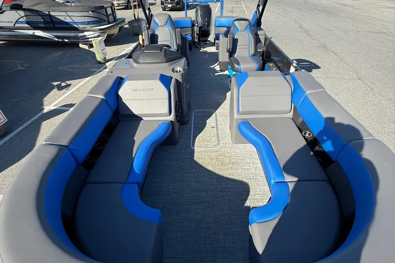 Slide: The Image of 2024 Berkshire 25RFX STS pontoon boat with blue and gray seating, docked outdoors. - 9