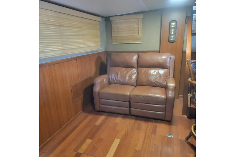 Slide: The Image of 1988 Chris-Craft 381 Catalina interior with leather sofa and wooden flooring. - 12