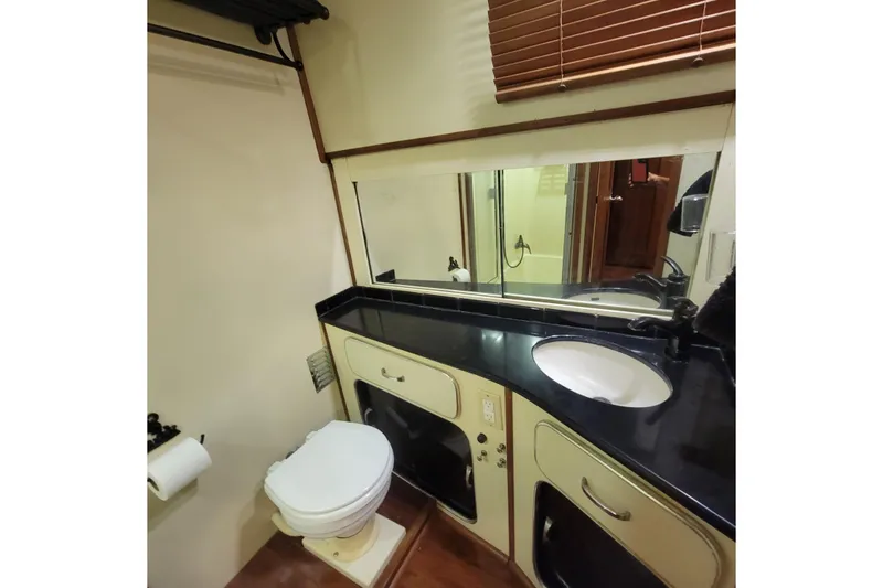 Slide: The Image of 1988 Chris-Craft 381 Catalina bathroom with sink, mirror, and toilet. - 14