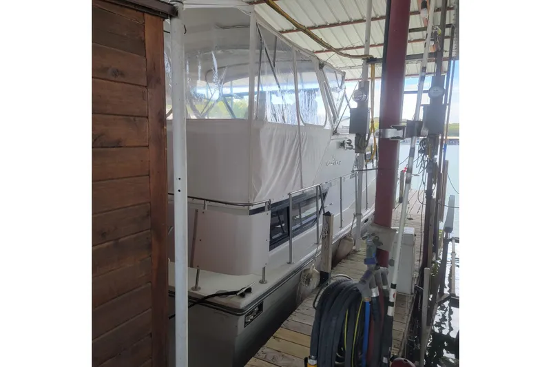 Slide: The Image of 1988 Chris-Craft 381 Catalina docked under a covered marina. - 2