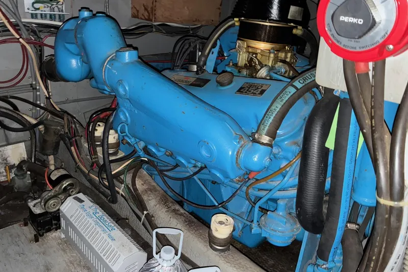 Slide: The Image of Engine compartment of 1988 Chris-Craft 381 Catalina, featuring a blue marine engine. - 21