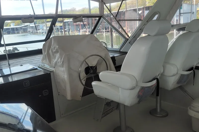 Slide: The Image of Interior of 1988 Chris-Craft 381 Catalina yacht with helm and white seating. - 4