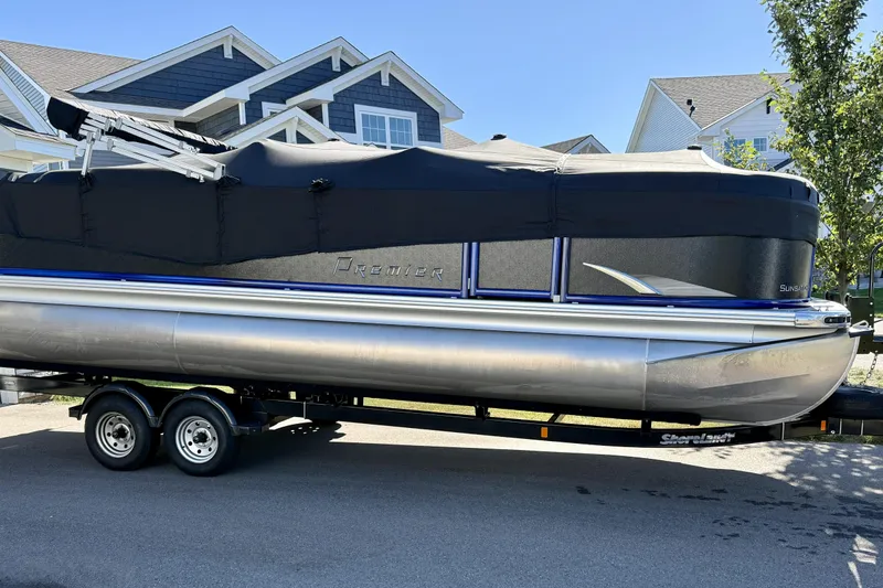 Slide: The Image of 2016 Premier 230 SunSation Echo RF pontoon boat on trailer, parked in residential area. - 10