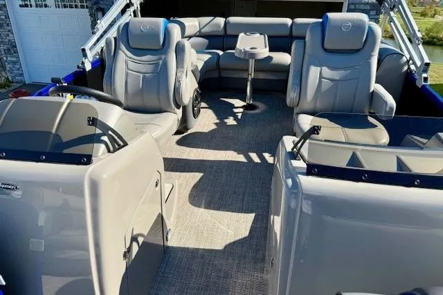 Slide: The Image of 2016 Premier 230 SunSation Echo RF pontoon boat interior with plush seating and table. - 17