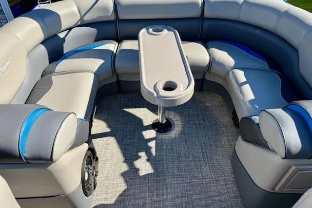 Slide: The Image of 2016 Premier 230 SunSation Echo RF boat interior with cushioned seating and central table. - 22