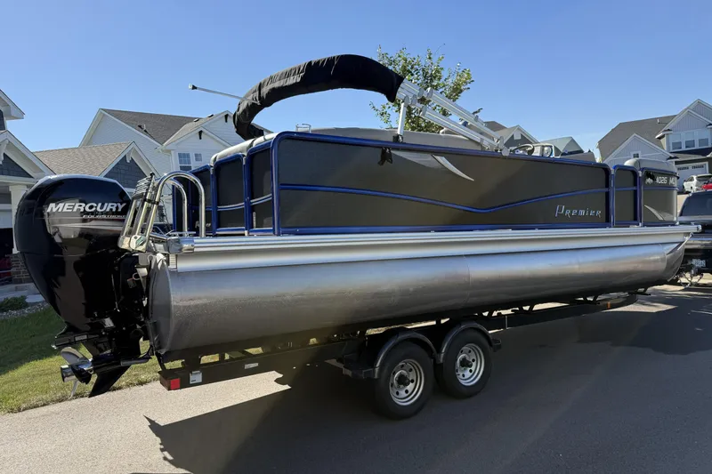 Slide: The Image of 2016 Premier 230 SunSation Echo RF pontoon boat on trailer, parked in residential area. - 3
