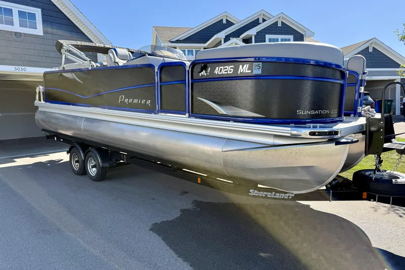 Slide: The Image of 2016 Premier 230 SunSation Echo RF pontoon boat on trailer, parked in driveway. - 4