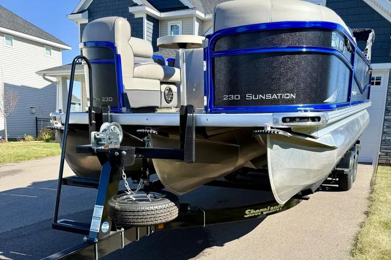 Slide: The Image of 2016 Premier 230 SunSation Echo RF pontoon boat on trailer in residential driveway. - 6