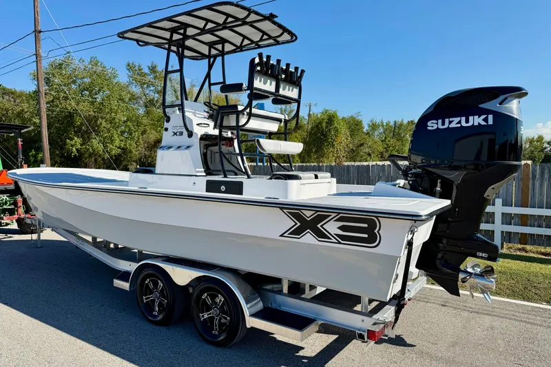 The Image of 2026 Shallow Sport 25 X3 boat on trailer, parked outdoors under a cloudy sky. - 2