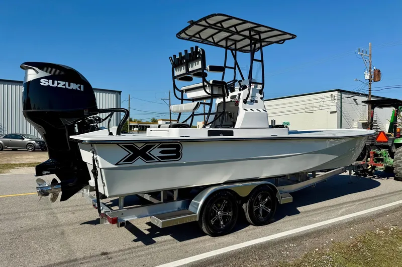 Slide: The Image of 2026 Shallow Sport 25 X3 boat with Suzuki 350 engine on trailer. - 4