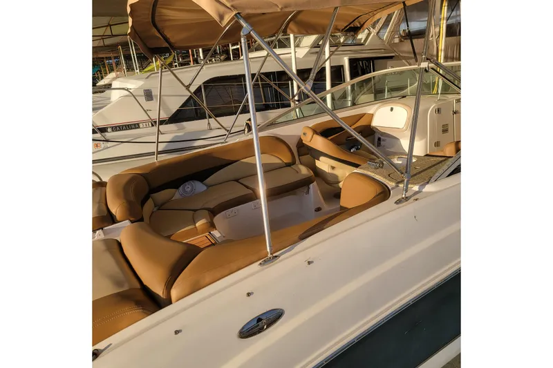 Slide: The Image of 2005 Chaparral 256 SSi boat interior with tan seating and canopy. - 5