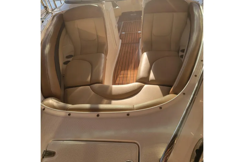 Slide: The Image of 2005 Chaparral 256 SSi boat interior with tan leather seating and wooden flooring. - 6