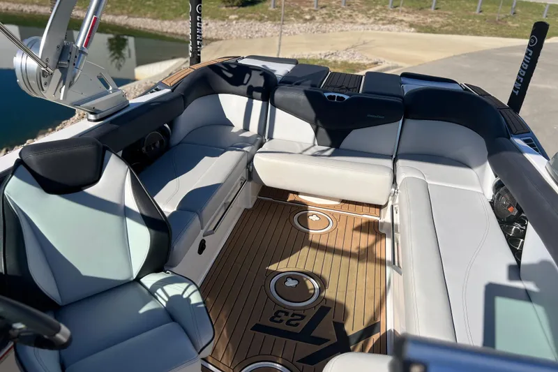Slide: The Image of Interior of 2020 MasterCraft XT23 boat with luxurious seating and teak flooring. - 10
