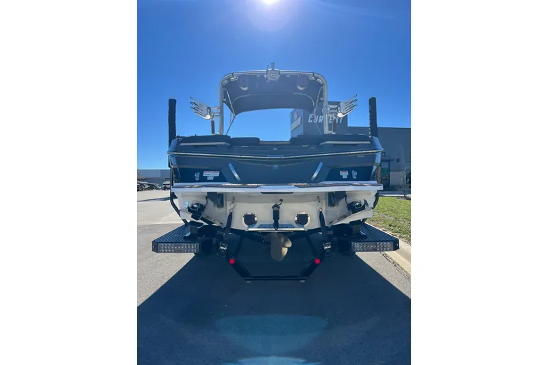 Slide: The Image of 2020 MasterCraft XT23 boat rear view under clear blue sky. - 3