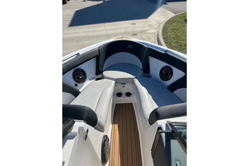 Slide: The Image of 2020 MasterCraft XT23 boat interior with cushioned seating and speakers. - 8