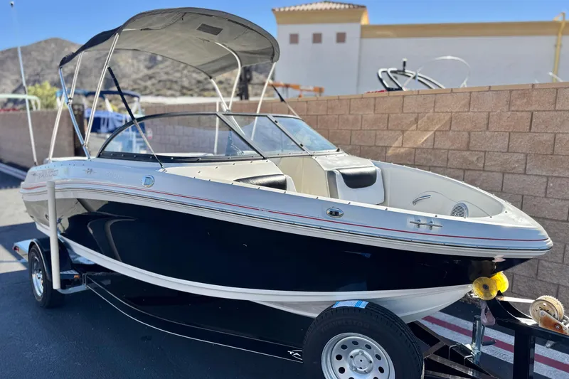 Slide: The Image of 2016 Tahoe 500 TS boat on trailer, parked outdoors with mountains in background. - 1