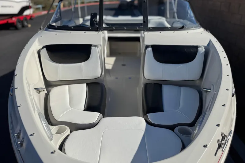 Slide: The Image of 2016 Tahoe 500 TS boat interior with white and black seating, cup holders, and windshield. - 10