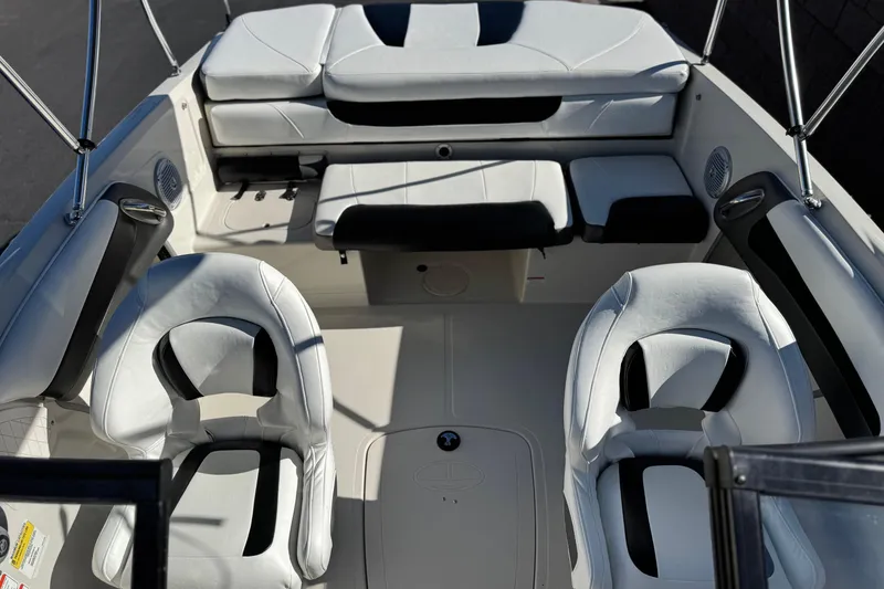 Slide: The Image of Interior of a 2016 Tahoe 500 TS boat with white seating and black accents. - 14