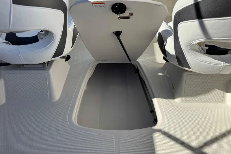 Slide: The Image of 2016 Tahoe 500 TS boat interior with open storage compartment and white seating. - 20