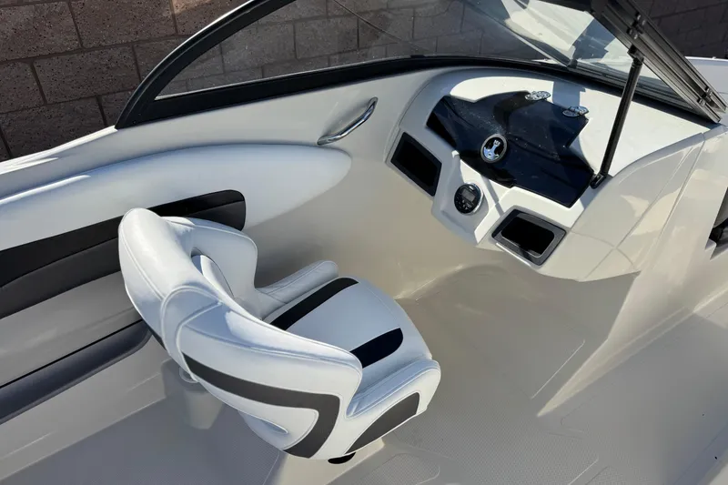 Slide: The Image of Interior of a 2016 Tahoe 500 TS boat with white seating and dashboard. - 21