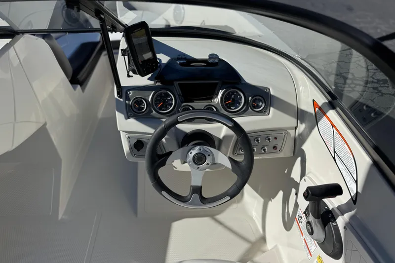 Slide: The Image of Cockpit view of 2016 Tahoe 500 TS boat with steering wheel and control panel. - 24