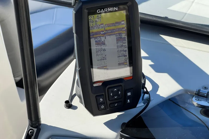 Slide: The Image of Garmin device on 2016 Tahoe 500 TS boat dashboard, displaying navigation data. - 25