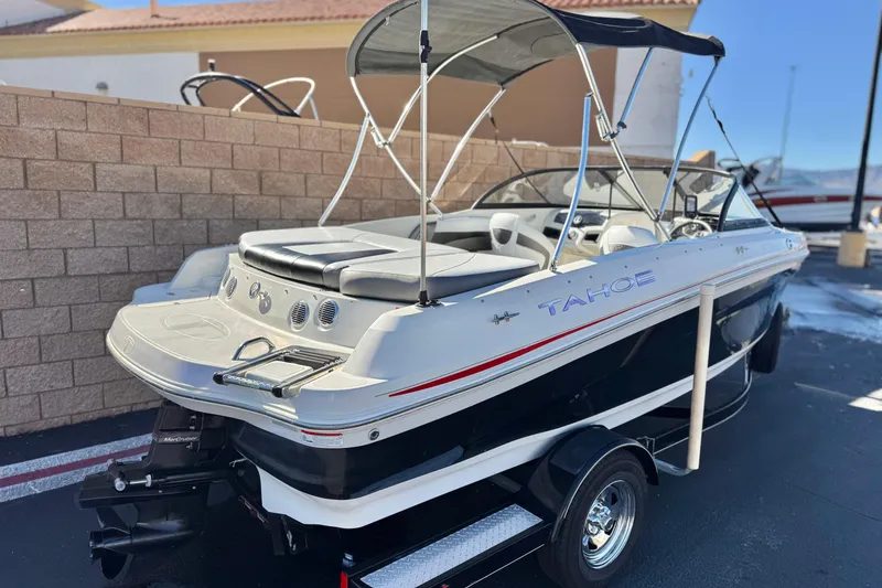 Slide: The Image of 2016 Tahoe 500 TS boat with canopy, parked on a trailer, side view. - 5