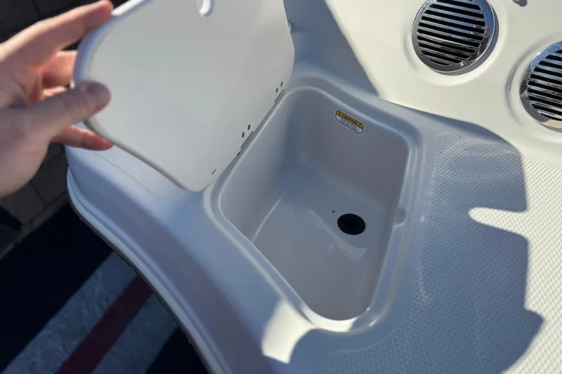 Slide: The Image of 2016 Tahoe 500 TS boat storage compartment with open lid and drainage hole. - 8