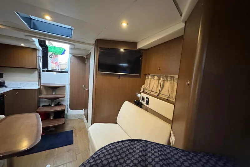 Slide: The Image of Interior of 2018 Sea Ray Sundancer 350 Coupe with modern furnishings and wood accents. - 10