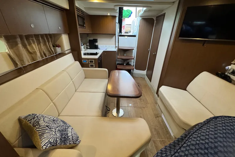 Slide: The Image of Luxurious interior of 2018 Sea Ray Sundancer 350 Coupe with modern seating and kitchenette. - 11