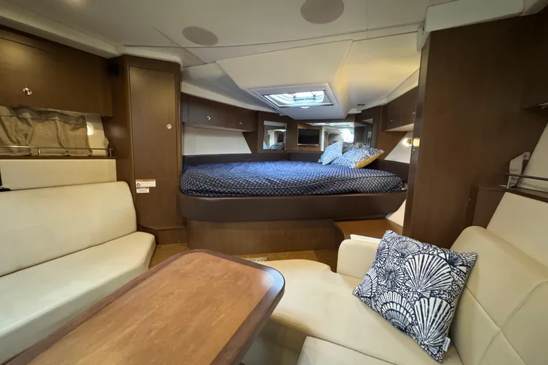 Slide: The Image of Luxurious interior of 2018 Sea Ray Sundancer 350 Coupe with cozy bed and seating area. - 15