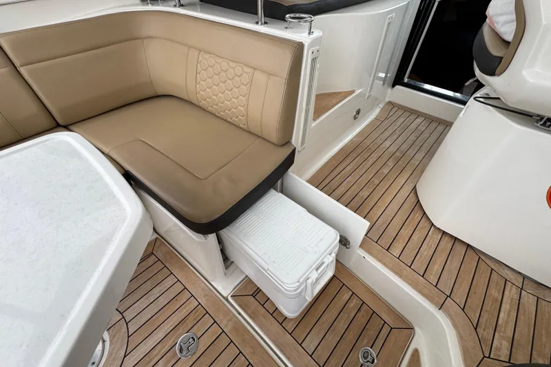Slide: The Image of 2018 Sea Ray Sundancer 350 Coupe interior with tan seating and wooden flooring. - 36