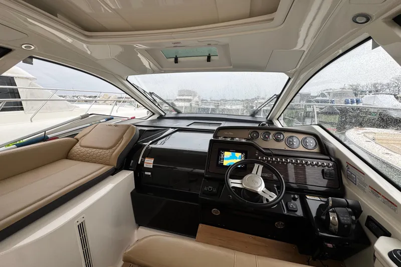 Slide: The Image of 2018 Sea Ray Sundancer 350 Coupe cockpit with modern navigation system and luxurious seating. - 40