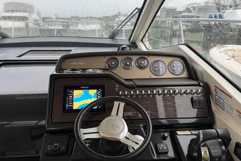 Slide: The Image of 2018 Sea Ray Sundancer 350 Coupe helm with navigation display and control panel. - 41