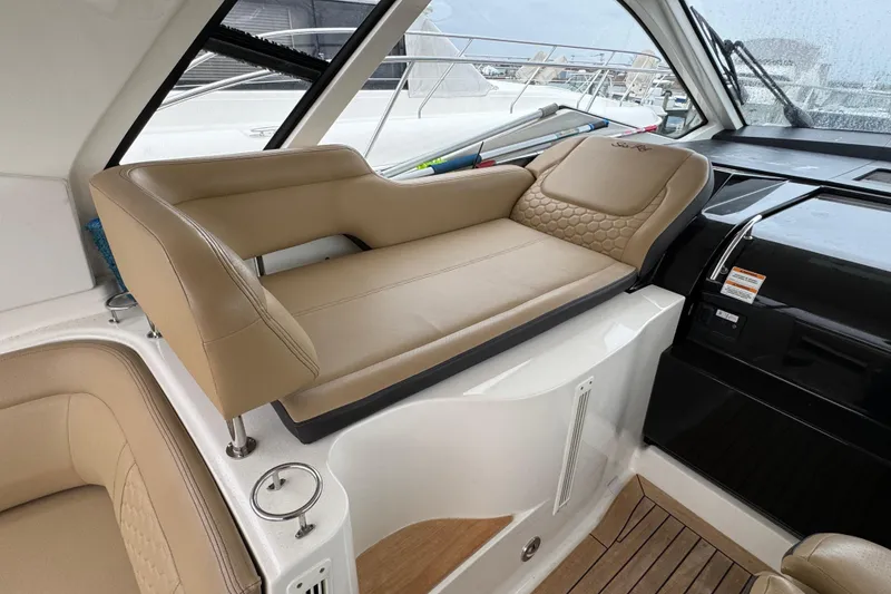 Slide: The Image of 2018 Sea Ray Sundancer 350 Coupe interior with beige seating and sleek design. - 44