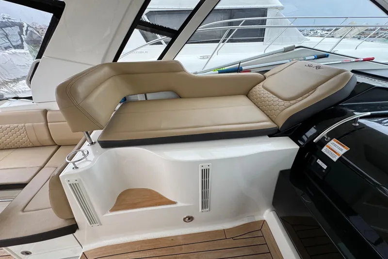 Slide: The Image of 2018 Sea Ray Sundancer 350 Coupe interior with beige seating and modern design. - 45