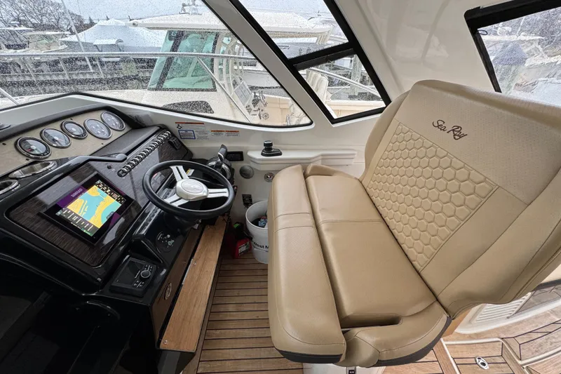 Slide: The Image of Interior of 2018 Sea Ray Sundancer 350 Coupe with steering wheel and navigation display. - 48
