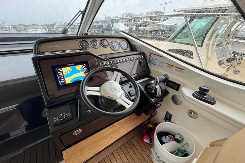 Slide: The Image of Cockpit of 2018 Sea Ray Sundancer 350 Coupe with navigation system and steering wheel. - 51