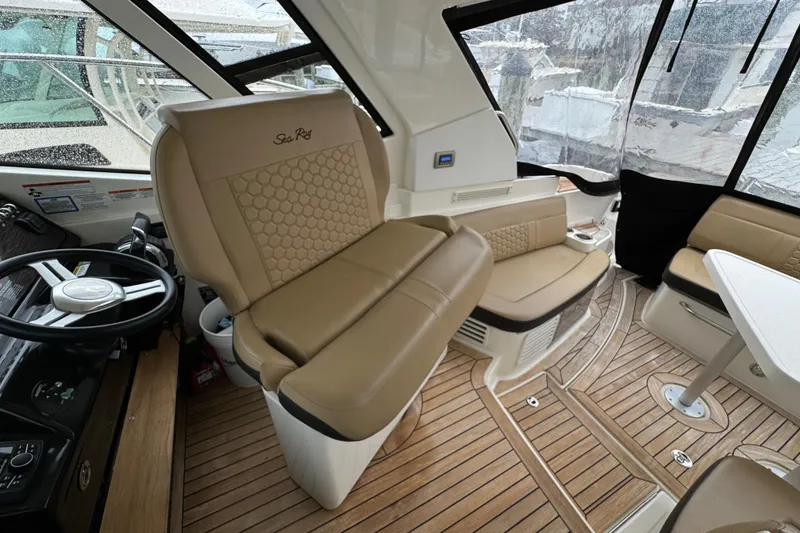 Slide: The Image of 2018 Sea Ray Sundancer 350 Coupe interior with tan leather seating and wooden flooring. - 52