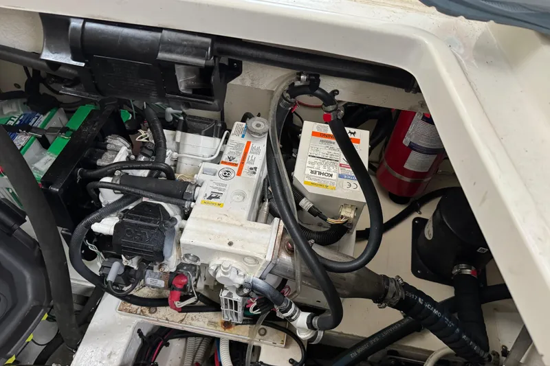 Slide: The Image of Engine compartment of a 2018 Sea Ray Sundancer 350 Coupe with visible components and wiring. - 66