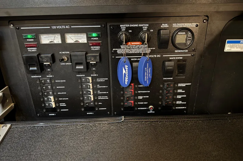 Slide: The Image of Control panel of a 2018 Sea Ray Sundancer 350 Coupe with various switches and meters. - 67