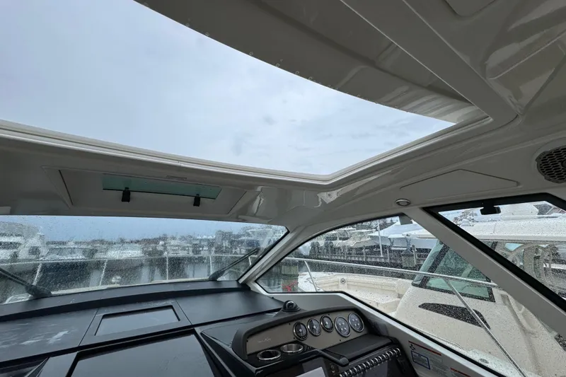 Slide: The Image of Interior view of 2018 Sea Ray Sundancer 350 Coupe with panoramic windows and dashboard. - 70
