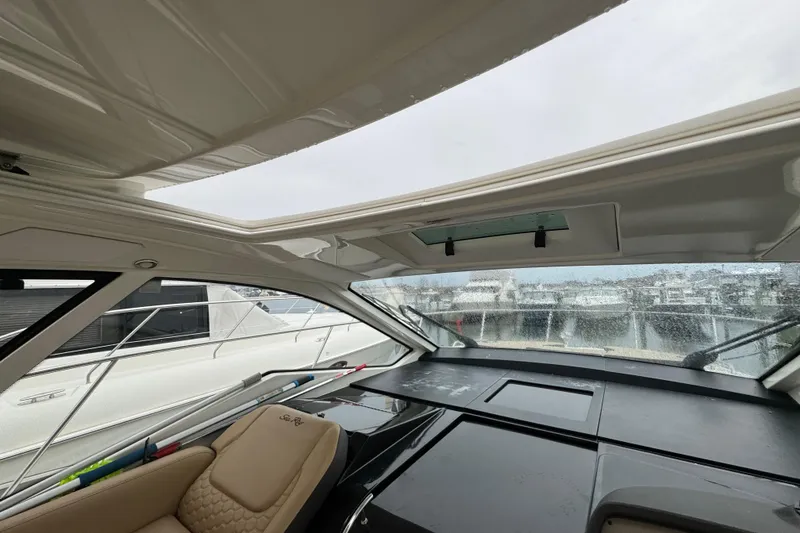 Slide: The Image of 2018 Sea Ray Sundancer 350 Coupe interior with panoramic windows and luxurious seating. - 72