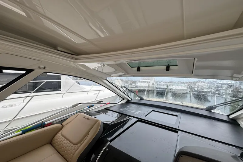Slide: The Image of Interior view of 2018 Sea Ray Sundancer 350 Coupe with helm and seating. - 74