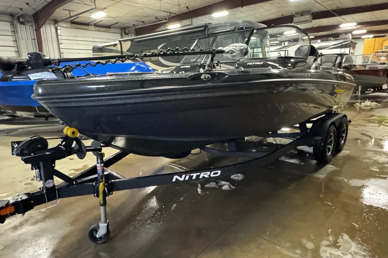 Slide: The Image of 2026 Nitro ZV19 Sport boat on trailer in indoor showroom. - 1