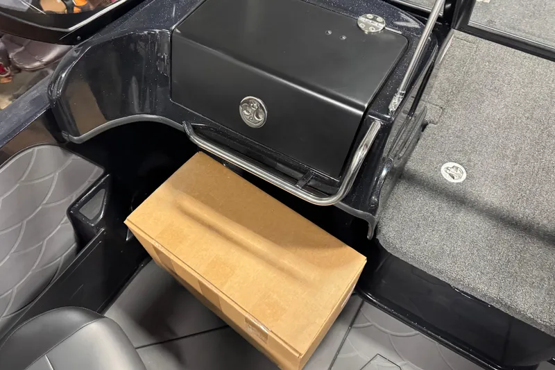 Slide: The Image of 2026 Nitro ZV19 Sport interior with storage compartment and cardboard box. - 16